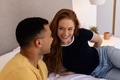 Young couple relaxing on bed, smiling and enjoying quality time together - PhotoDune Item for Sale