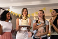 Celebrating birthday, diverse friends enjoying cake and laughter at home party - PhotoDune Item for Sale
