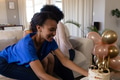 Smiling woman placing birthday cake on table during celebration at home - PhotoDune Item for Sale