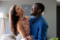 Couple laughing and embracing at home, enjoying joyful and intimate moment together - PhotoDune Item for Sale