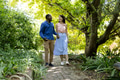 Couple walking hand in hand on garden path, enjoying nature and conversation - PhotoDune Item for Sale