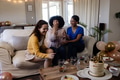 Women laughing and celebrating birthday with cake and balloons in living room - PhotoDune Item for Sale