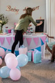 Decorating baby shower, woman writing on chalkboard with gifts and balloons around - PhotoDune Item for Sale