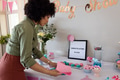 Woman preparing baby shower decorations, arranging table with pink and blue napkins - PhotoDune Item for Sale