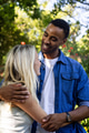 Couple embracing outdoors, smiling and enjoying sunny day in park - PhotoDune Item for Sale