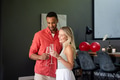 Couple celebrating with champagne glasses at home, smiling and enjoying moment - PhotoDune Item for Sale