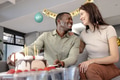 Couple celebrating birthday at home, smiling and enjoying cake together - PhotoDune Item for Sale