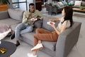 Friends enjoying dessert and conversation on cozy living room sofa - PhotoDune Item for Sale