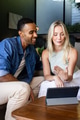 Couple at home video chatting on tablet, smiling and enjoying conversation - PhotoDune Item for Sale