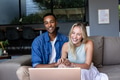 Smiling couple using laptop at home, enjoying video call together - PhotoDune Item for Sale