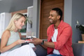 Smiling couple celebrating birthday with cake at home, enjoying joyful moment - PhotoDune Item for Sale