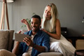Couple at home enjoying video call on tablet, smiling and relaxing on couch - PhotoDune Item for Sale