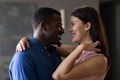 Couple embracing at home, smiling and gazing into each other's eyes lovingly - PhotoDune Item for Sale