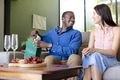 Couple exchanging gifts at home, smiling and enjoying cozy celebration - PhotoDune Item for Sale