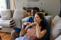 Couple relaxing at home, smiling and taking selfie with tablet on couch - PhotoDune Item for Sale
