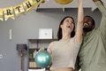 Happy couple celebrating birthday at home, holding colorful balloons and smiling - PhotoDune Item for Sale