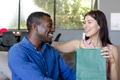 Couple exchanging gifts at home, smiling and enjoying joyful moment together - PhotoDune Item for Sale