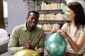 Inflating colorful balloons, friends celebrating festive occasion at home together - PhotoDune Item for Sale