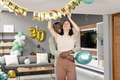 Decorating living room with birthday banner, couple celebrating special occasion together - PhotoDune Item for Sale