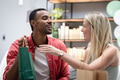 Joyful couple exchanging gifts at home, celebrating special occasion together - PhotoDune Item for Sale
