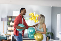 Couple celebrating birthday at home with colorful balloons and decorations - PhotoDune Item for Sale