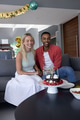 Couple celebrating birthday at home with cake and decorations, smiling joyfully - PhotoDune Item for Sale