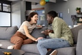 Laughing together, friends enjoying conversation on couch at home with tablets - PhotoDune Item for Sale