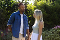 Couple enjoying romantic moment in garden, holding hands and smiling warmly - PhotoDune Item for Sale