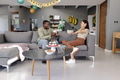 Celebrating birthday, African American man and woman laughing on sofa at home - PhotoDune Item for Sale