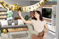 Decorating with balloons and banner, couple celebrating birthday at home, smiling - PhotoDune Item for Sale