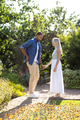 Couple holding hands in sunny garden, enjoying romantic moment together - PhotoDune Item for Sale