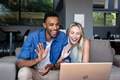 Happy couple video chatting on laptop at home, waving and smiling warmly - PhotoDune Item for Sale