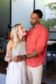 Couple celebrating at home, holding champagne glasses and smiling at each other - PhotoDune Item for Sale
