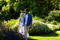 Couple walking in lush garden, enjoying nature and each other's company - PhotoDune Item for Sale