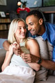 Couple relaxing on couch, smiling and enjoying quality time at home - PhotoDune Item for Sale