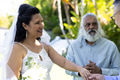 Holding hands during outdoor senior wedding, bride smiling joyfully with guests present - PhotoDune Item for Sale