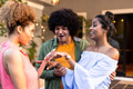 Celebrating engagement, Diverse friends admiring ring with excitement at outdoor gathering - PhotoDune Item for Sale