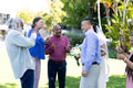 Blowing bubbles at joyful senior wedding party, diverse group celebrating outdoors - PhotoDune Item for Sale