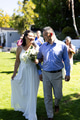 Celebrating senior wedding, bride walking joyfully with father in garden holding bouquet - PhotoDune Item for Sale