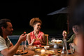Diverse friends enjoying outdoor dinner party, laughing and sharing food by candlelight - PhotoDune Item for Sale