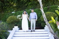 Walking down garden steps, bride and groom holding hands smiling joyfully - PhotoDune Item for Sale