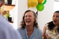 Laughing joyfully, senior woman at lively celebration with friends outdoors - PhotoDune Item for Sale