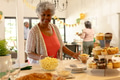 At family celebration, African American woman having snacks with cupcakes and decorations - PhotoDune Item for Sale