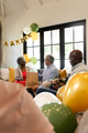 Family celebrating birthday at home, exchanging gifts and enjoying festive balloons - PhotoDune Item for Sale