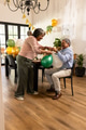 Elderly couple decorating with balloons at home, preparing for festive celebration - PhotoDune Item for Sale
