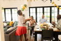 Elderly woman carrying birthday cake while friends clapping and celebrating at home - PhotoDune Item for Sale