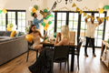 Friends decorating living room with balloons and banners for birthday celebration - PhotoDune Item for Sale