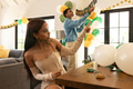 Decorating living room with balloons and banners for festive celebration at home - PhotoDune Item for Sale