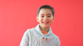 Portrait Of Young Boy Against Red Studio Background Smiling At Camera - PhotoDune Item for Sale