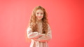 Portrait Of Girl With Long Red Hair Against Red Studio Background Smiling At Camera And Folding Arms - PhotoDune Item for Sale